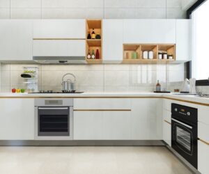 Modern modular kitchen design in Ghana with white cabinets, built-in oven, open wooden shelves, and minimalist decor by Euro Homes Interior.
